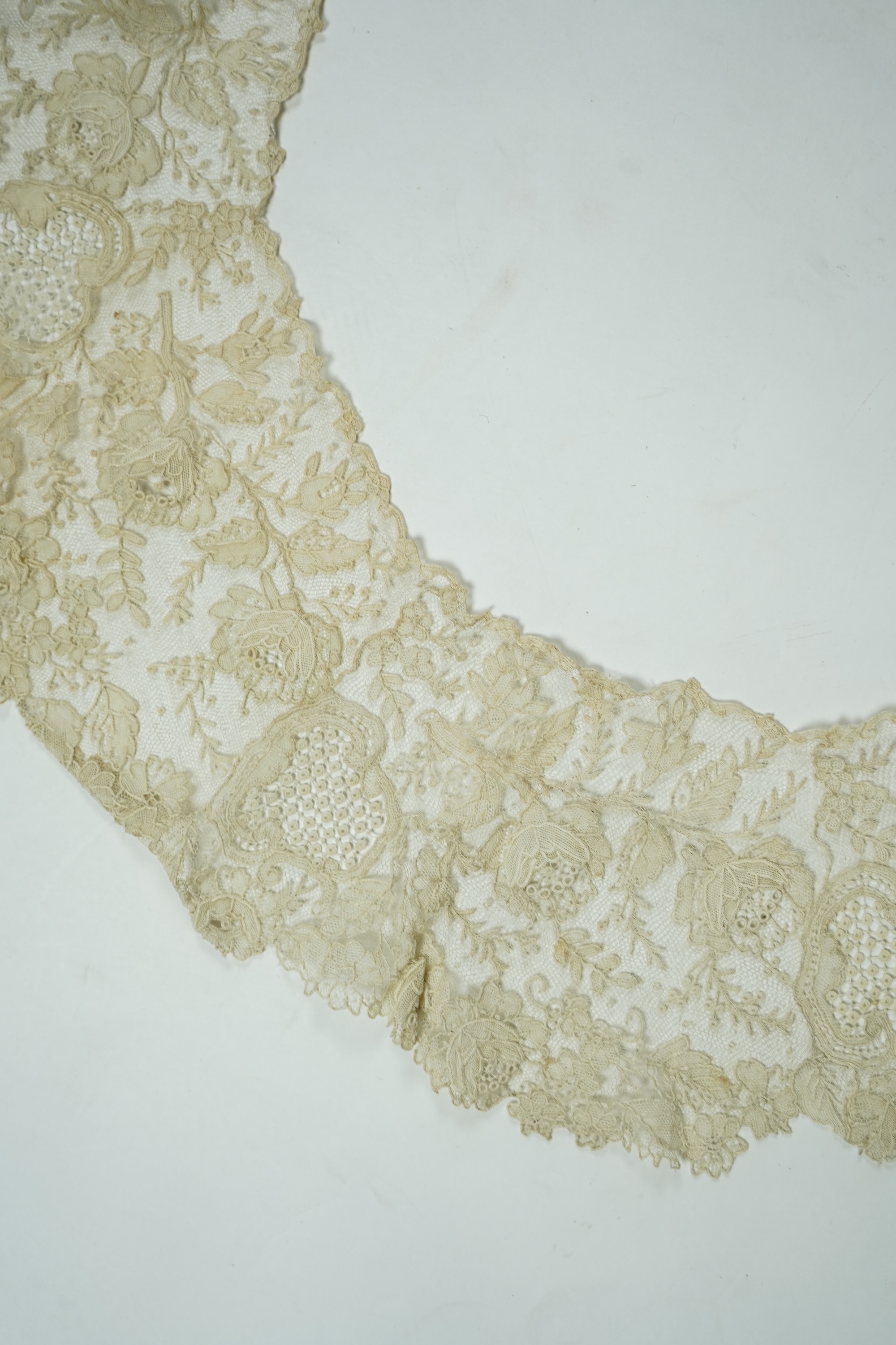 A 19th century Brussels Point de Gaz needle lace collar, lappet and wedding hankie, possibly part of a trousseau. The collar having thirty four needle lace raised flower heads within the design. The collar 100cm long x 1